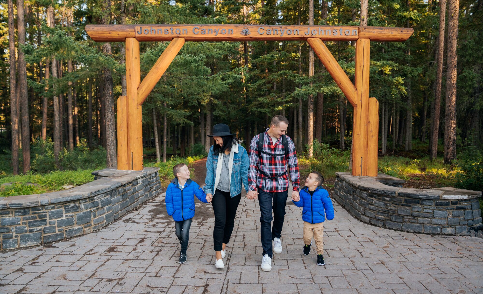 A family walks out of the Johnston Canyon trail in Banff National Park.